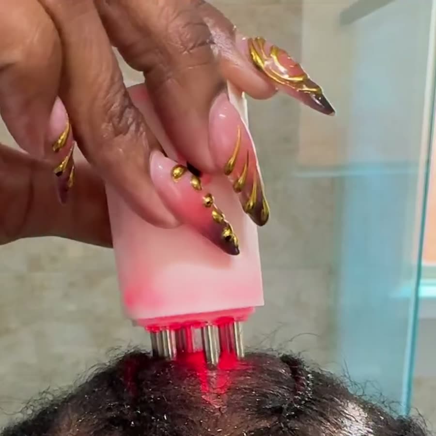 Customer using the Follicle Activator 3.0 on her braided scalp